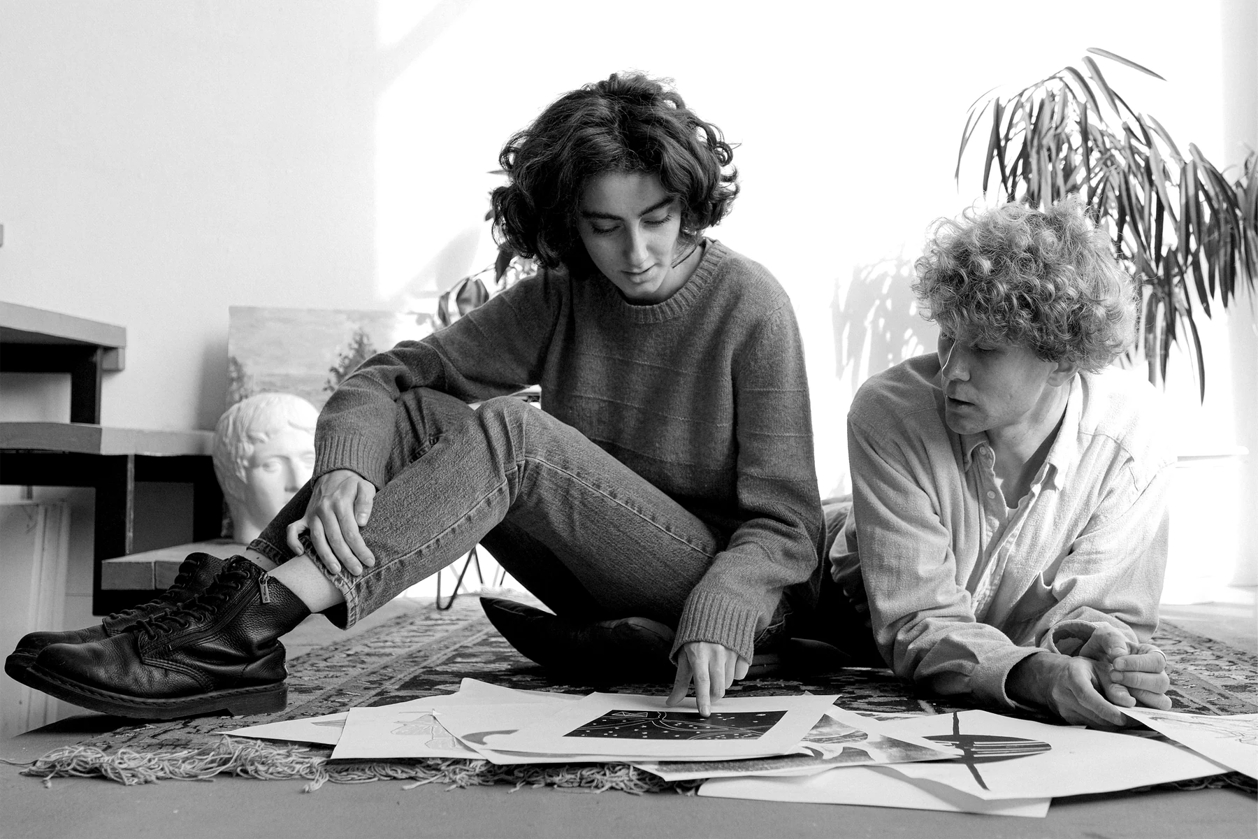 Two people sitting together and reviewing creative work