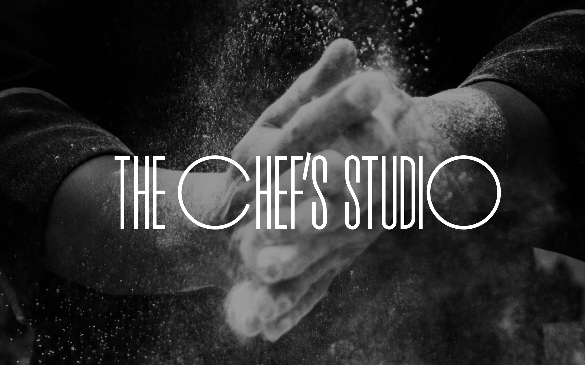 The Chef’s Studio wordmark over a monochrome photograph of hands with flour